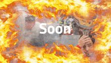 a man in a helmet is surrounded by flames and the word soon is visible