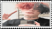 a person with red hair is taking a selfie with a phone .