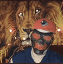 a man wearing a skull mask and a hat is standing in front of a lion