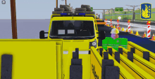 a yellow truck with the number 7 on the side is driving down a road