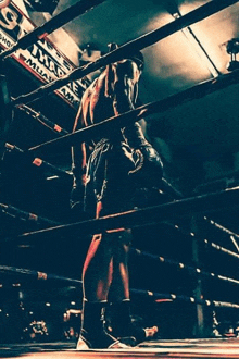 a man in a boxing ring with a sign that says muay thai on it