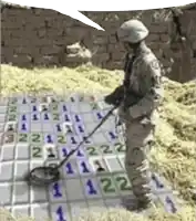 a soldier is using a metal detector on a board with numbers 1 through 12 on it