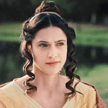 a woman in a yellow dress has a headband on her hair