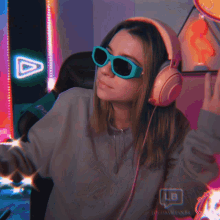 a woman wearing headphones and sunglasses has a watermark that says ls