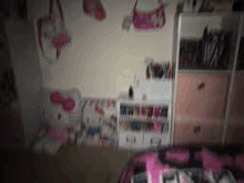 a girl 's bedroom with a bed , dresser , shelf , and hello kitty .