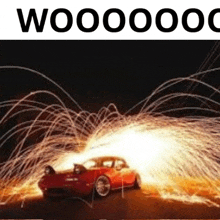 a red car is surrounded by sparks and the words woooooom are visible