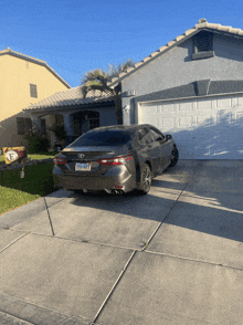 a toyota car with a california license plate is parked in front of a home