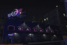 galaxy night club is advertised on a billboard above the entrance