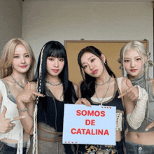 a group of girls are holding a sign that says somos de catalina