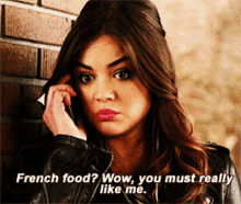 a woman talking on a cell phone with the words french food wow you must really like me below her