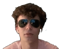 a man with curly hair is wearing a pair of aviator sunglasses .