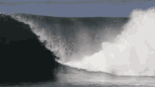 a surfer is riding a large wave in the ocean