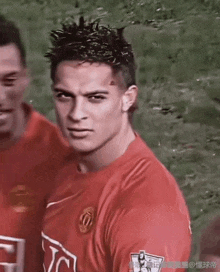 a soccer player wearing a red jersey with the number 10 on the front