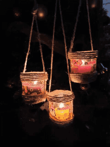 three candles hanging from a rope with nutella written on them