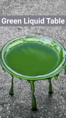 a green liquid table with a gray background