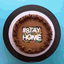 a chocolate cake with the words #stay home on it