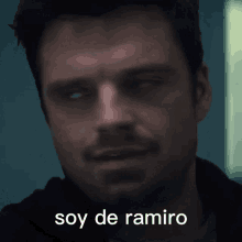 a close up of a man 's face with the words soy de ramiro written on the bottom .