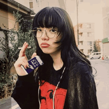 a woman smoking a cigarette while wearing glasses