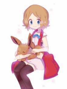 a girl is holding a brown eevee in her lap