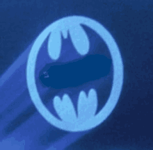 a batman logo is glowing in the dark