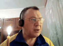 a man wearing headphones and glasses is talking