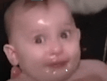 a close up of a baby 's face with a white arrow pointing to it