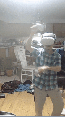 a man wearing a virtual reality headset is dancing