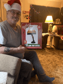 a man in a santa hat is holding a gremlins leg lamp prop replica