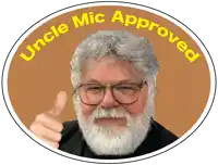 a man with glasses and a beard is giving a thumbs up and the words " uncle mic approved " around him