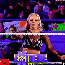 a woman is standing in a wrestling ring with the words extreme rules behind her