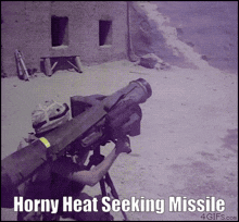 a picture of a man holding a missile with horny heat seeking missile written below it