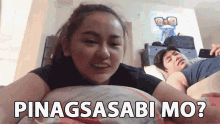 a woman is laying on a bed next to a man with the words pinagsasabi mo written on it