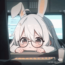 a girl with bunny ears and glasses is sitting in front of a computer screen