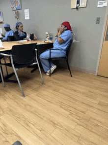 a female staff member sits at a table in a room