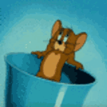 a cartoon mouse is sitting in a blue bucket .