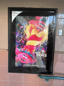 a movie poster for trolls is displayed in a black frame