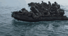 a group of soldiers are riding in a raft in the water .