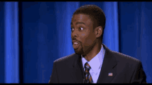 a man in a suit and tie with an american flag on his jacket