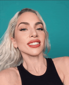 a close up of a woman 's face with a blue background