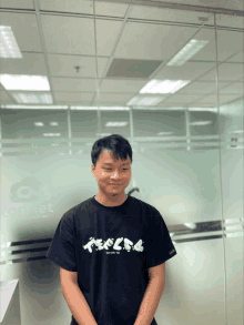 a man wearing a black t-shirt that says ' tokyo ' on it