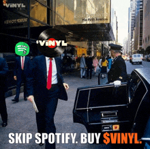 a man in a suit and tie is getting out of a limousine with a vinyl record on his head