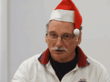 a man wearing a santa hat and a aussie shirt