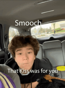 a boy in the back seat of a car with the words smooch that kiss was for you