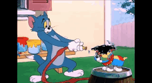 a cartoon of tom and jerry playing with a dog