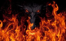 a demon with red eyes is surrounded by fire