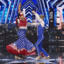 a boy and a girl are dancing on a stage in front of a sign that says ' got talent '