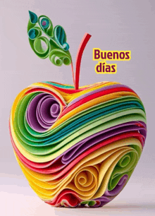 a colorful apple with the words buenos dias written above it