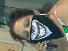 a woman wearing a black face mask with a skull on it