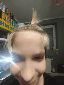 a girl taking a picture of herself in front of a shelf of energy drinks including monster