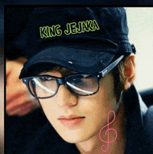 a man wearing glasses and a hat that says " king jejaka "